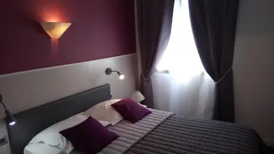 Un ou plusieurs lits dans un hébergement de l'établissement Hôtel Montespan
