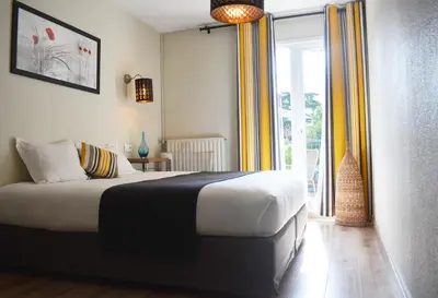 Un ou plusieurs lits dans un hébergement de l'établissement Logis Hotel Epi d'Or