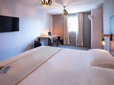 Un ou plusieurs lits dans un hébergement de l'établissement Ibis Styles Cognac