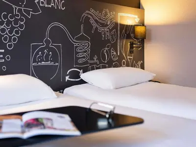 Un ou plusieurs lits dans un hébergement de l'établissement Ibis Styles Cognac