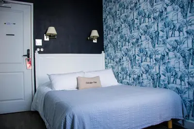 Un ou plusieurs lits dans un hébergement de l'établissement Hôtel Restaurant L'Atelier des Cousins