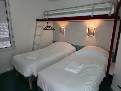 Un ou plusieurs lits dans un hébergement de l'établissement Brit Hotel Essentiel Poitiers Gare du Futuroscope