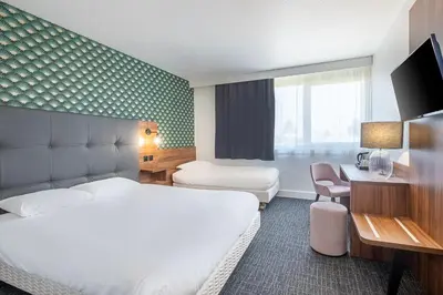 Un ou plusieurs lits dans un hébergement de l'établissement Hôtel Akena Poitiers Nord Futuroscope