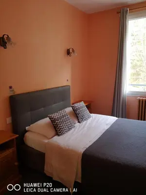 Un ou plusieurs lits dans un hébergement de l'établissement Hôtel Le Memphis