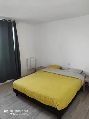 Un ou plusieurs lits dans un hébergement de l'établissement Appartement Futuroscope-E'