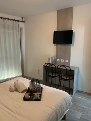 Un ou plusieurs lits dans un hébergement de l'établissement Hôtel Au Relais des Lilas