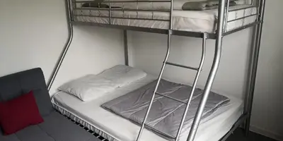 Un ou plusieurs lits dans un hébergement de l'établissement Appartement meublé proche du futuroscope