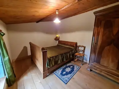 Un ou plusieurs lits dans un hébergement de l'établissement Maison de charme avec WiFi au cœur du Marais Poitevin, jardin clos, barque et vélos, 4 chambres - FR-1-426-146