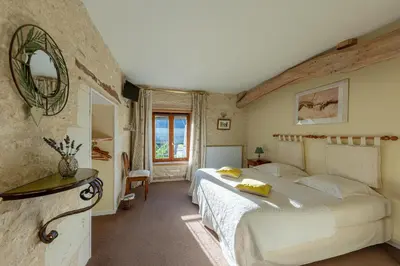 Un ou plusieurs lits dans un hébergement de l'établissement La maison de Charlotte - chambres d'hôtes-Futuroscope