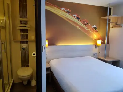 Un ou plusieurs lits dans un hébergement de l'établissement Hôtel Inn Design & Restaurant Rochefort