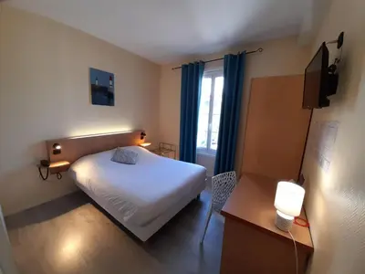Un ou plusieurs lits dans un hébergement de l'établissement Hotel de France