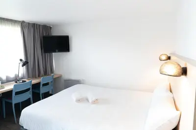 Un ou plusieurs lits dans un hébergement de l'établissement Hôtel Inn Design La Rochelle