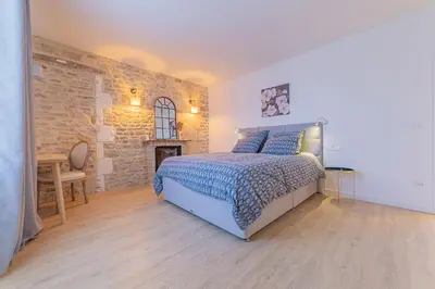 Un ou plusieurs lits dans un hébergement de l'établissement Les gîtes du château