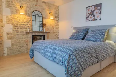 Un ou plusieurs lits dans un hébergement de l'établissement Les gîtes du château