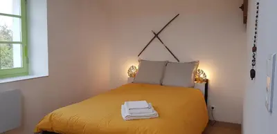 Un ou plusieurs lits dans un hébergement de l'établissement Maison chaleureuse et familiale.