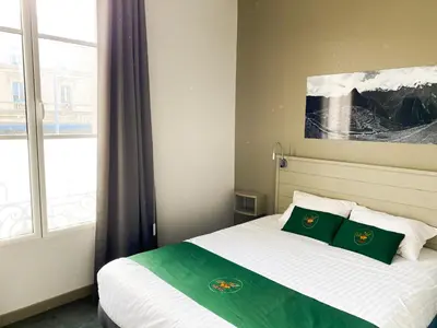 Un ou plusieurs lits dans un hébergement de l'établissement Colette Hôtel