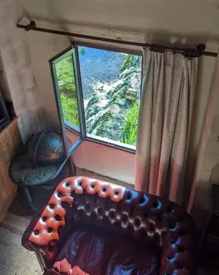 Coin salon dans l'établissement Chambres en maison d'hôtes Le Moulin d'Annepont