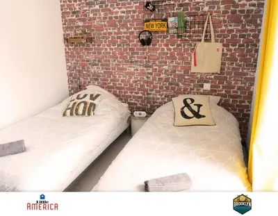 Un ou plusieurs lits dans un hébergement de l'établissement Little America - Appart Hôtel 3km Futuroscope