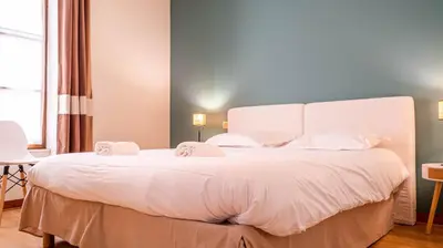 Un ou plusieurs lits dans un hébergement de l'établissement Le Havre Citadin - Maison de ville à Poitiers